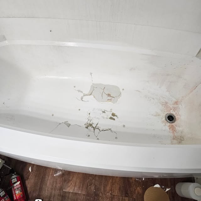 Damaged bathtub surface before repair and refinishing